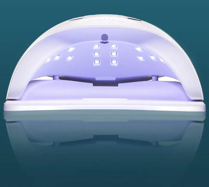 White nail polish baking lamp with UV LED lights and timer controls for gel manicure drying