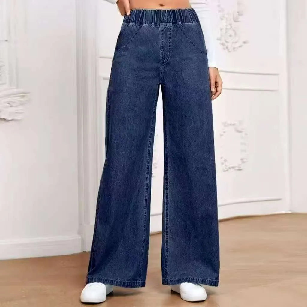 Light blue washed wide-leg jeans on a hanger, showing the straight-leg silhouette and mid-waist design.