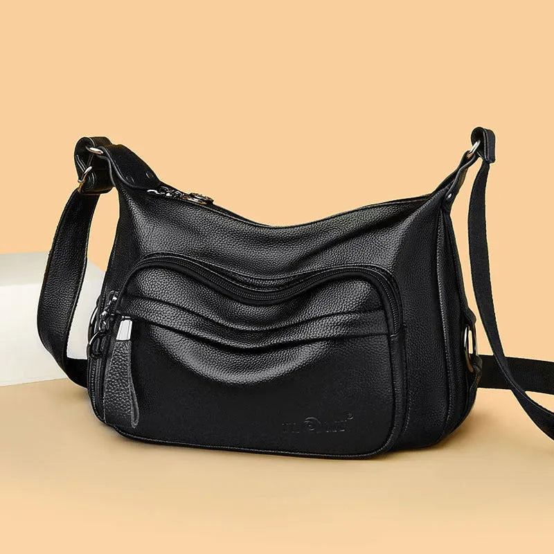 Large blue women's shoulder bag with multiple internal compartments and crossbody strap