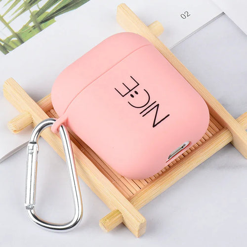 Black and pink AirPods earphone covers with decorative flower and smiley face back designs.