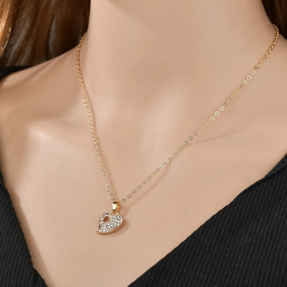 Gold electroplated women's jewellery set with love bell patterns including earrings, pendant and adjustable bracelet