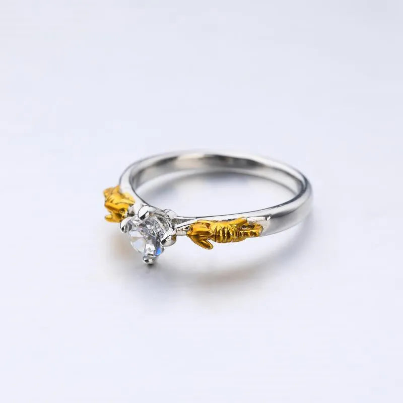 Copper crown crystal ring in black gold colour on a neutral background.
