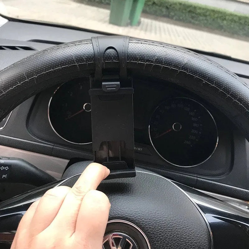 Black steering wheel phone clip mount holder showing adjustable clip and phone placement