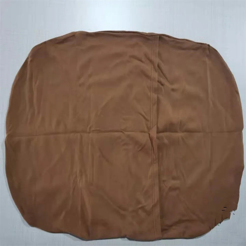 Beige portable cotton baby nest crib for newborn infants on a bed.