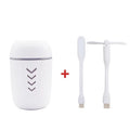 Blue X3 portable columnar humidifier with USB cable on a car dashboard.