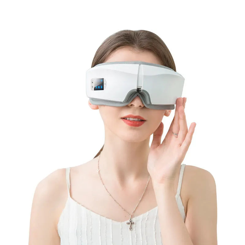 White USB eye massager with PU eye mask, 180-degree folding design, LCD screen and Bluetooth music.