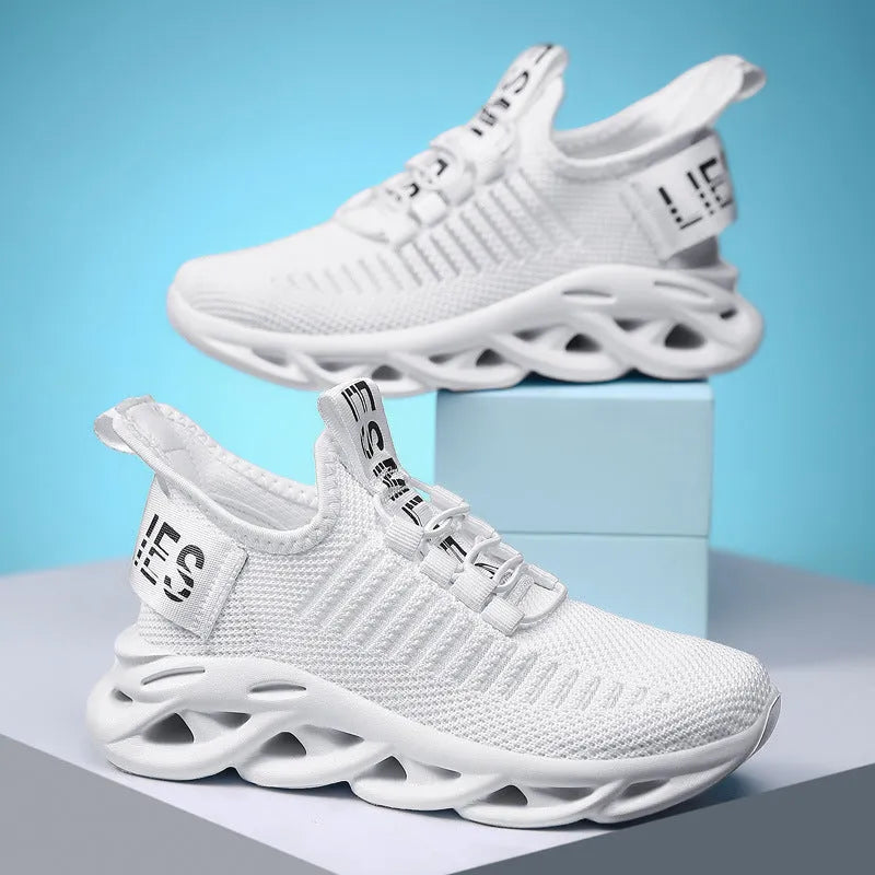 Children's fabric sneakers with Velcro strap in black, khaki, and white colours on a neutral background.