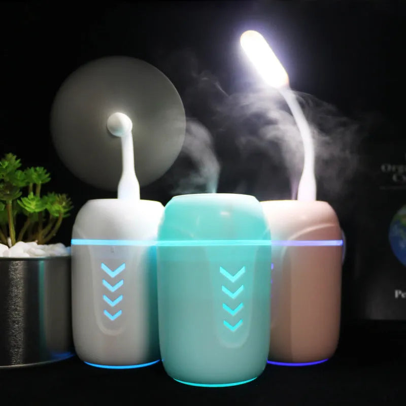 Blue X3 portable columnar humidifier with USB cable on a car dashboard.