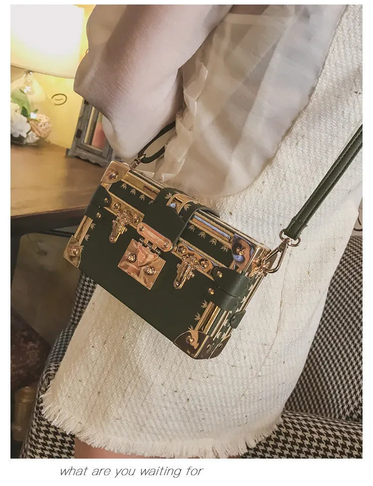 Women's hard-sided black PU shoulder bag with single strap and flap closure