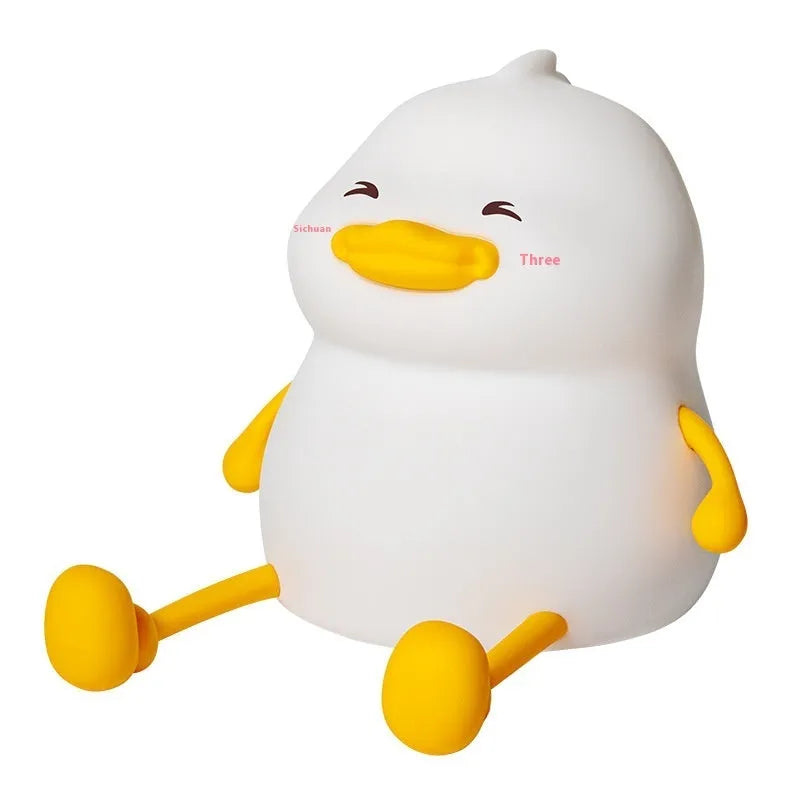 Chubby silicone rechargeable night light with phone holder on a desk