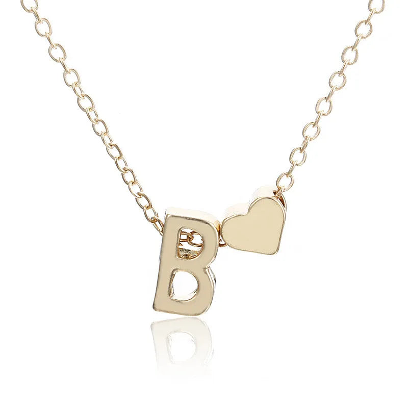 Gold and silver alloy peach heart shaped letter pendant necklace charm on a chain.