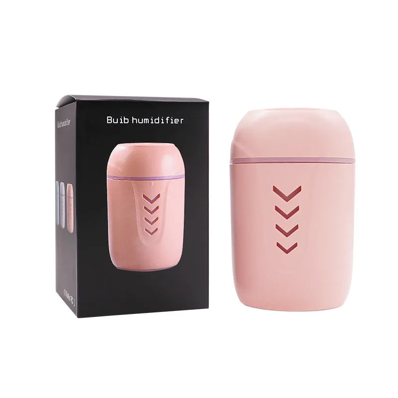 Blue X3 portable columnar humidifier with USB cable on a car dashboard.