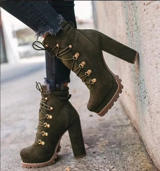 Women's suede ankle boots with a thick high heel, round toe, and decorative buckle on a waterproof platform.