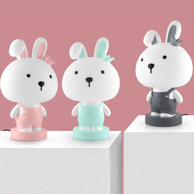 Cartoon animal table lamp in random bear, cattle, rabbit, or tiger design with plastic shade and LED light.