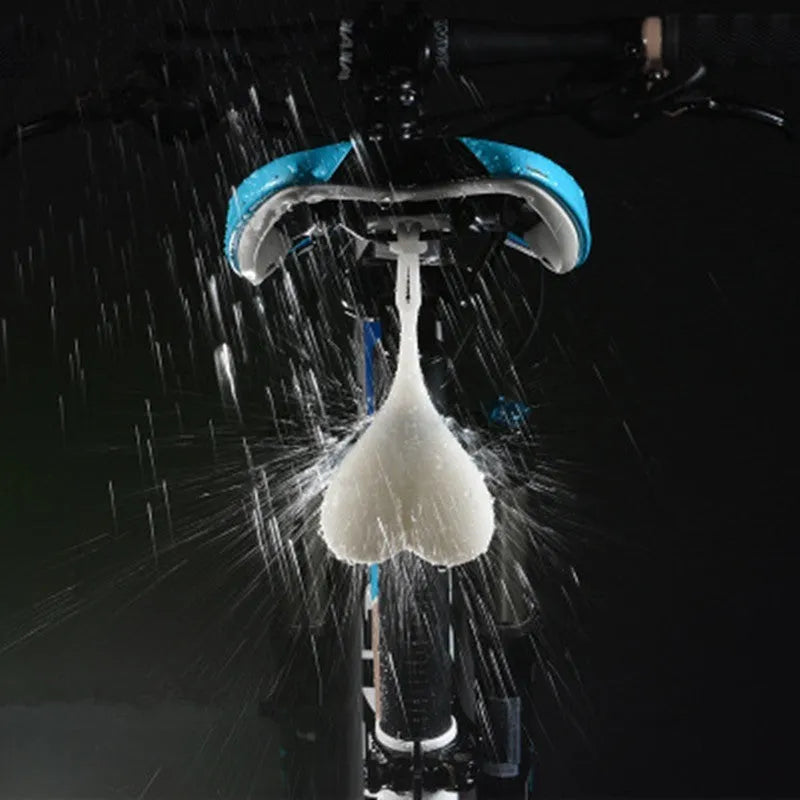 Heart-shaped silicone bike rear light, 15 cm long, touch activated, waterproof, in red blue green.
