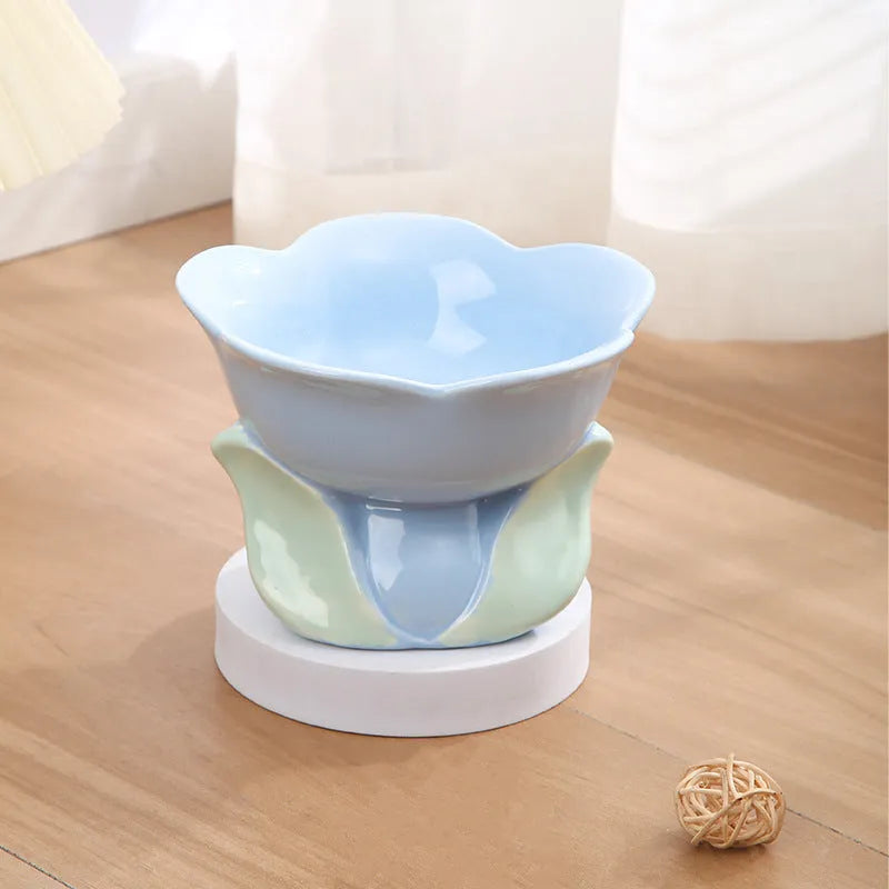 Blue ceramic raised pet bowl with floral pattern and non-slip base for cat or small dog.