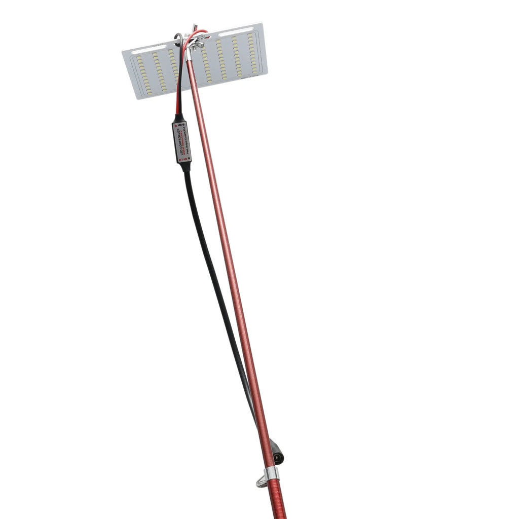 White LED fishing rod light unit with remote control next to extended telescopic pole