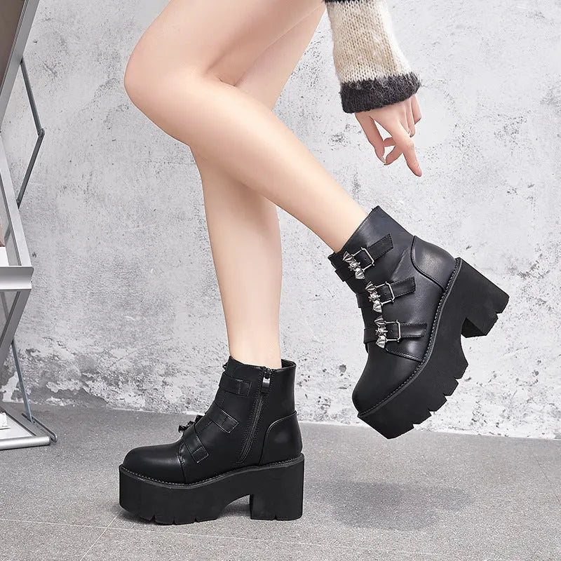 Black women's gothic punk Martin boots with bat buckle and side zipper on a thick heel.