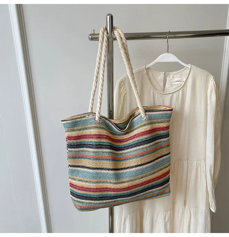 Blue straw woven nylon shoulder bag with a large capacity and polyester lining.
