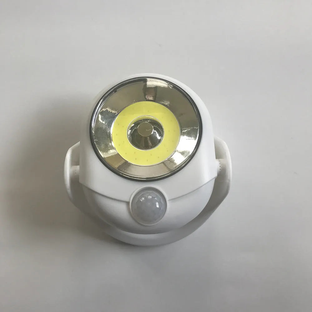 White Atomic Angel induction lamp with dimensions 13.3cm wide by 9.8cm deep by 15.8cm tall