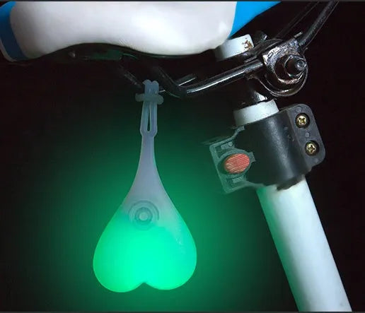 Heart-shaped silicone bike rear light, 15 cm long, touch activated, waterproof, in red blue green.