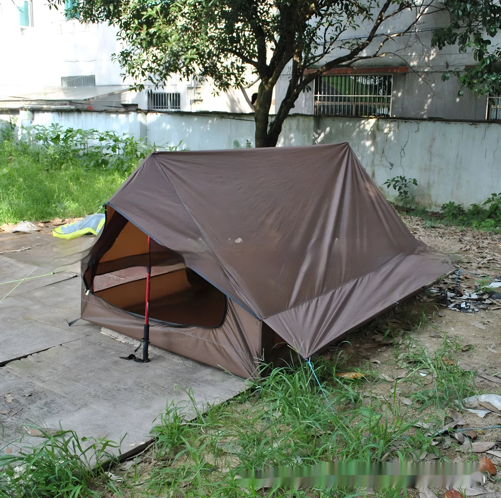 Brown and white pole-free A-line cabin tent set up with hiking canes, showing spacious interior
