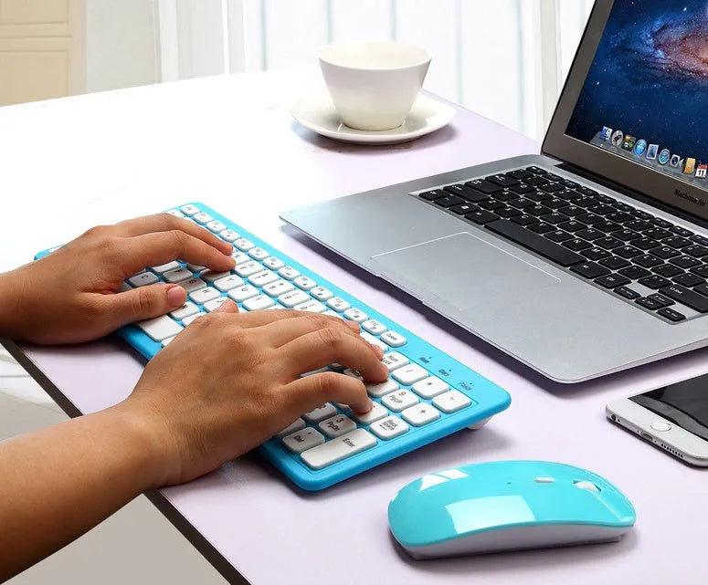 Black wireless keyboard and mouse set with USB receiver on wooden desk