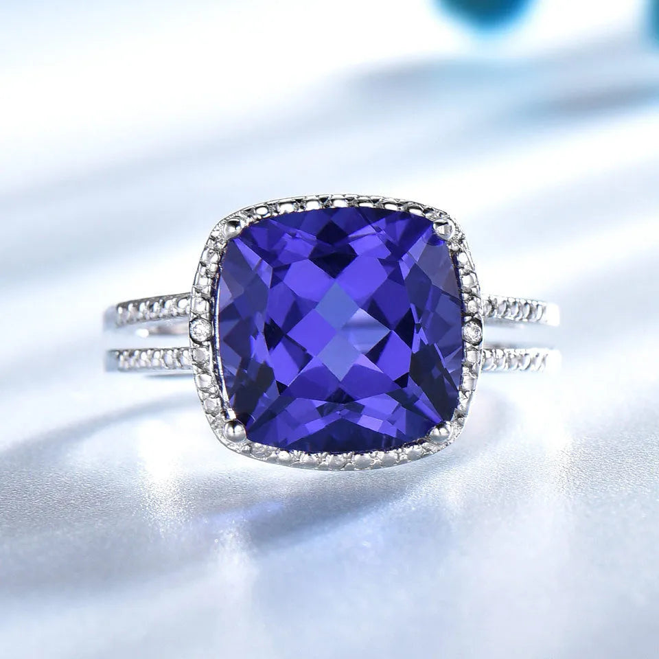 Close-up of a blue Tanzanite stone set in a polished 925 Sterling Silver women's ring.