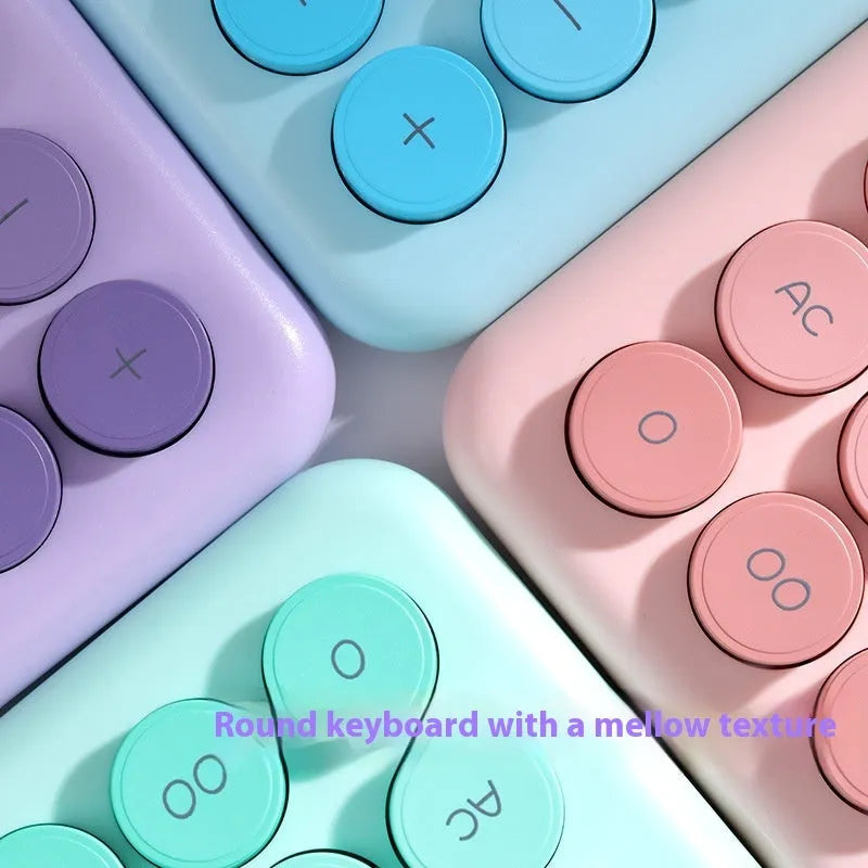 Dopamine gradient colour desk calculator in violet, pink, blue, or mint green on a desk.