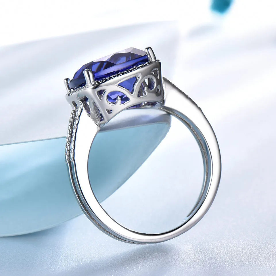 Close-up of a blue Tanzanite stone set in a polished 925 Sterling Silver women's ring.