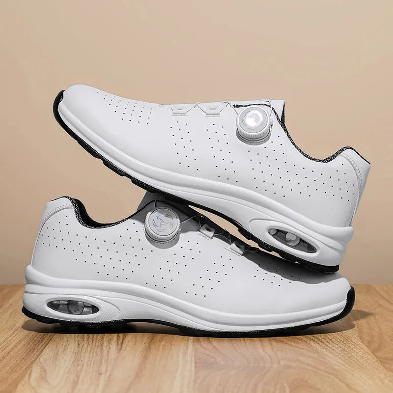 Low-top black and white casual tennis shoes with mesh upper and flat composite sole.