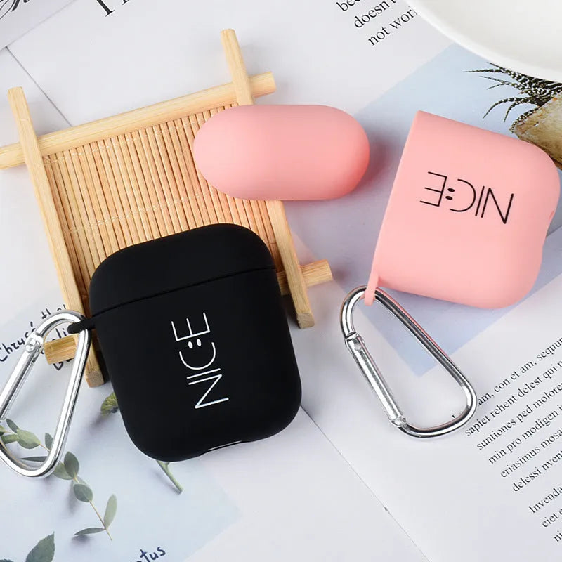 Black and pink AirPods earphone covers with decorative flower and smiley face back designs.
