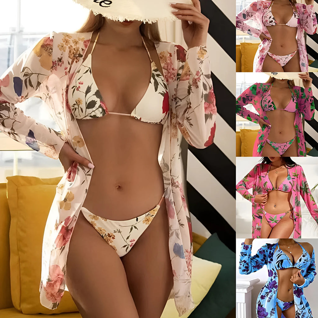 Women's floral printed mesh cover-up blouse, bra, and swim trunks three-piece swimsuit set laid flat.