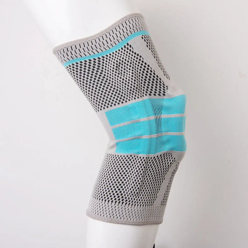 Sky blue elastic fibre knee pad for sports, shown in size L on a knee.