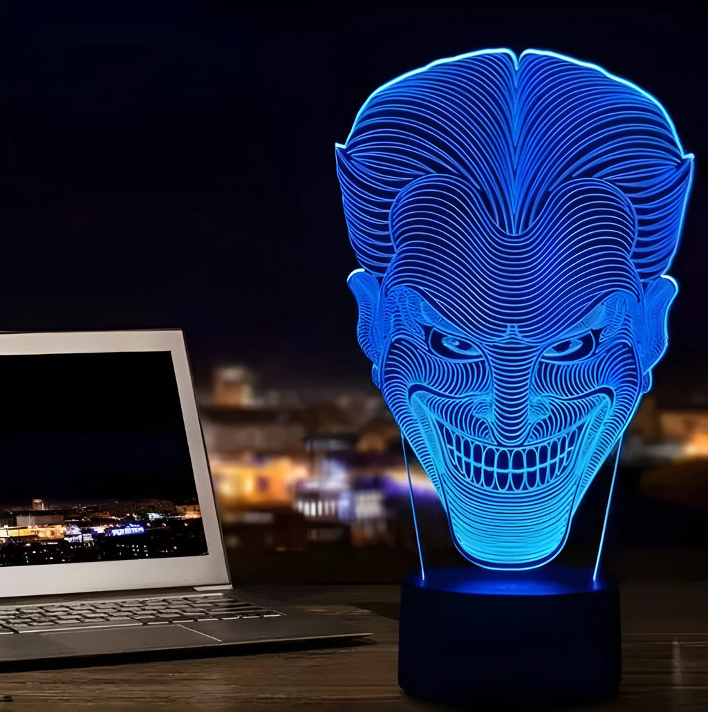 A 3D acrylic LED lamp displaying a gradient of colours, sitting on a square base with a USB cable.