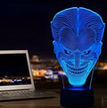 A 3D acrylic LED lamp displaying a gradient of colours, sitting on a square base with a USB cable.
