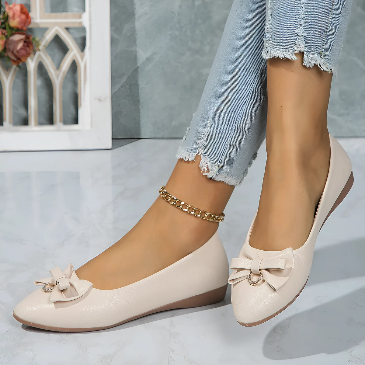 Women's beige casual flat shoes with a bowknot detail, shallow mouth, round toe, and flat rubber sole.