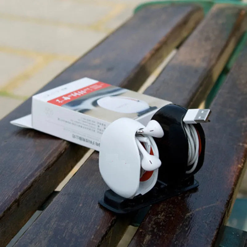 Automatic earphone cable winder retractor in assorted colours on a white background.