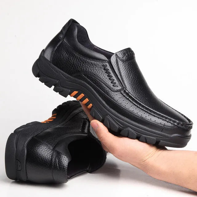 Business casual leather slip-on shoes in black and brown colours showing rubber sole and professional design