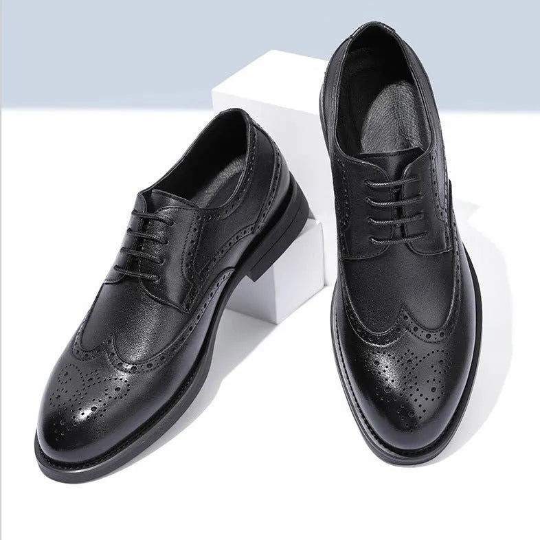 Men's black brogue leather shoes with decorative perforations and lace-up front.