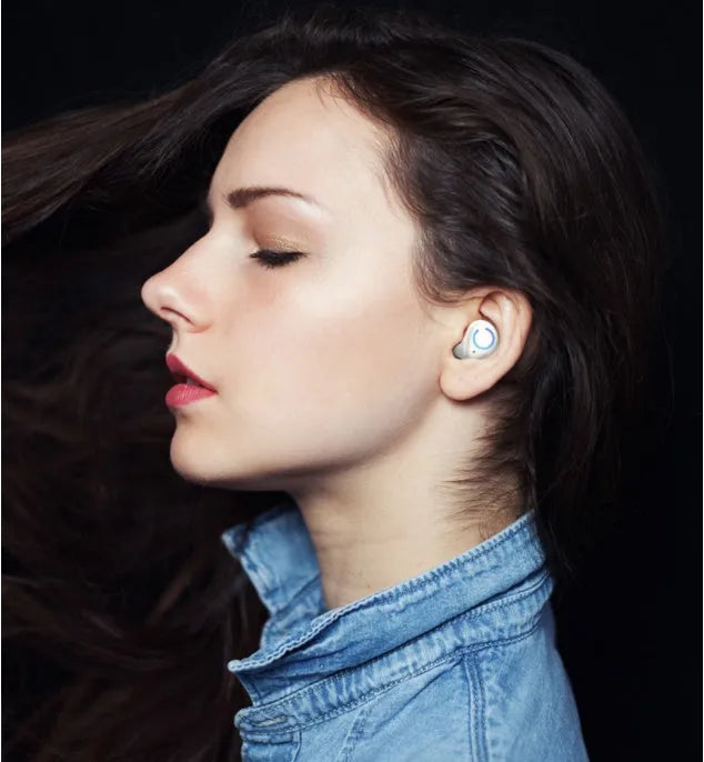 Black and white M18 true wireless in-ear Bluetooth headset with compact charging case.