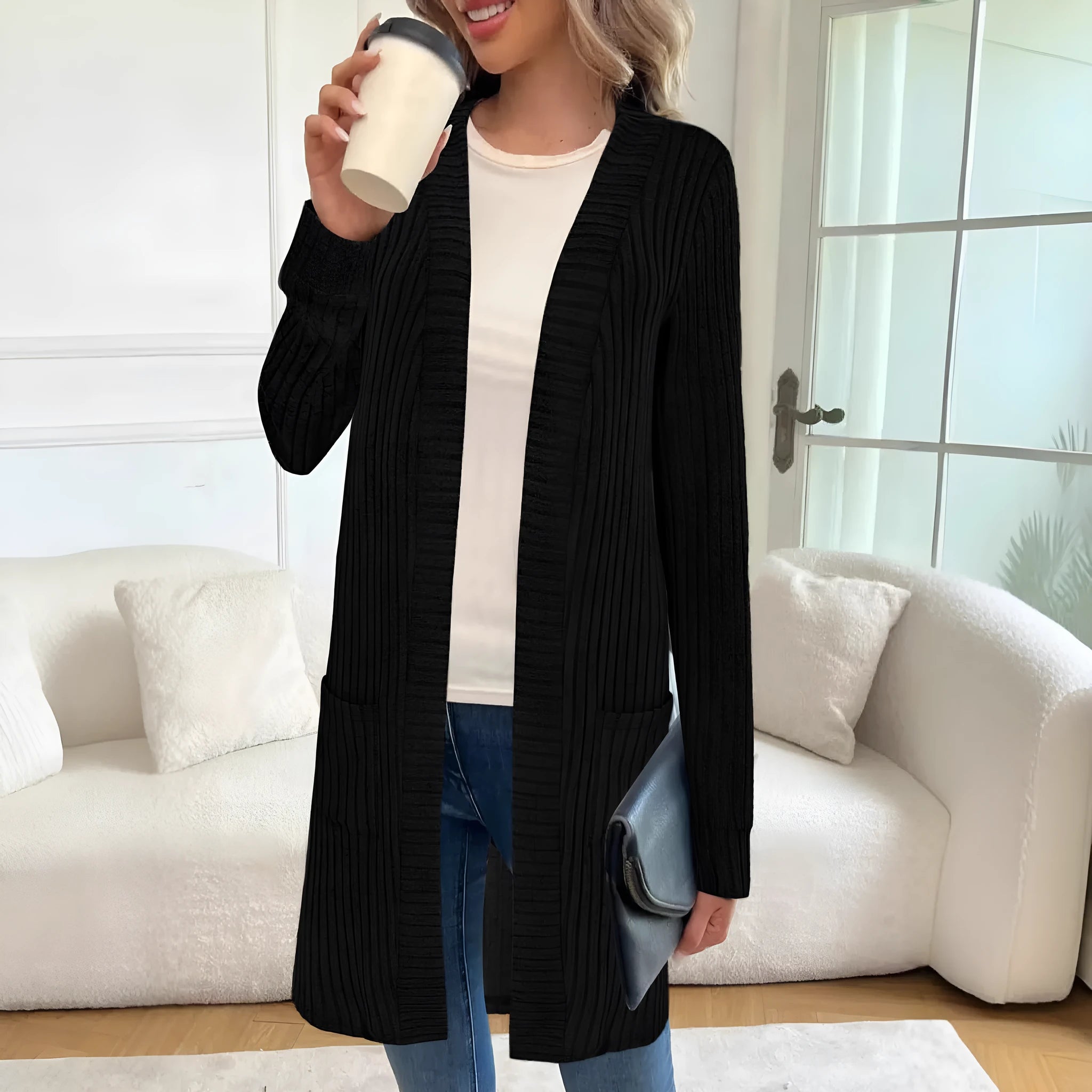 A woman's long sleeve loose-fit knitted cardigan jacket with pockets in wine red.