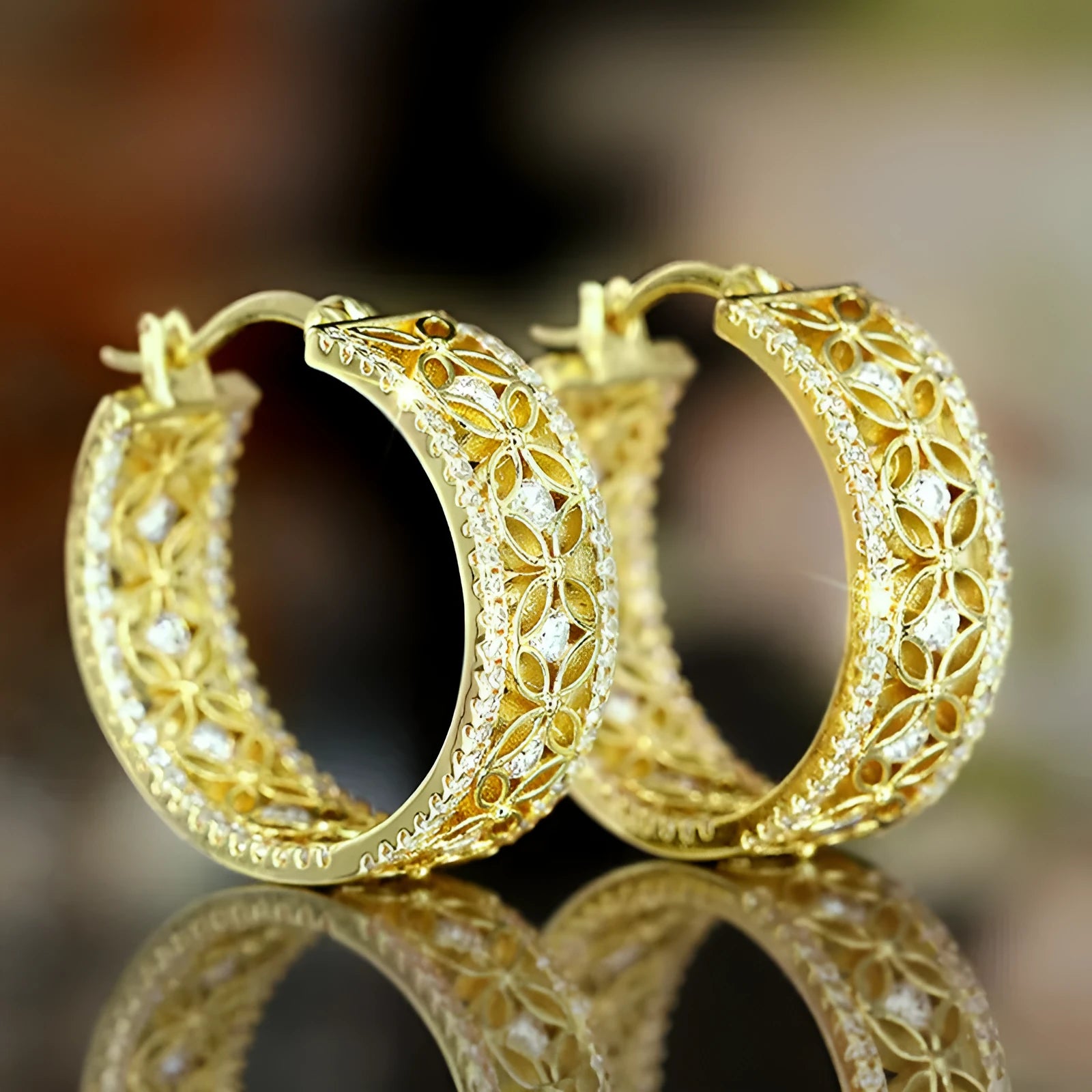 Copper ear clips with horse eye, flower and butterfly design on geometric shapes in yellow gold finish