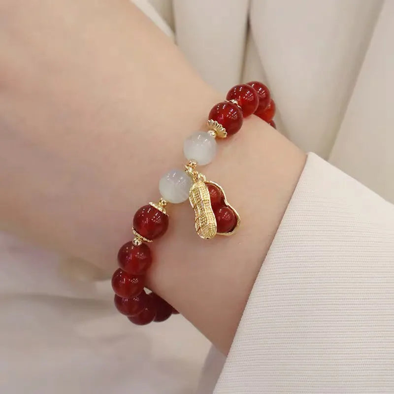 Chinese style handmade glass bead bracelet with bamboo joint elements on a white background.