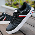 A pair of standard sports shoes shown in a choice of black, grey, or white colour.