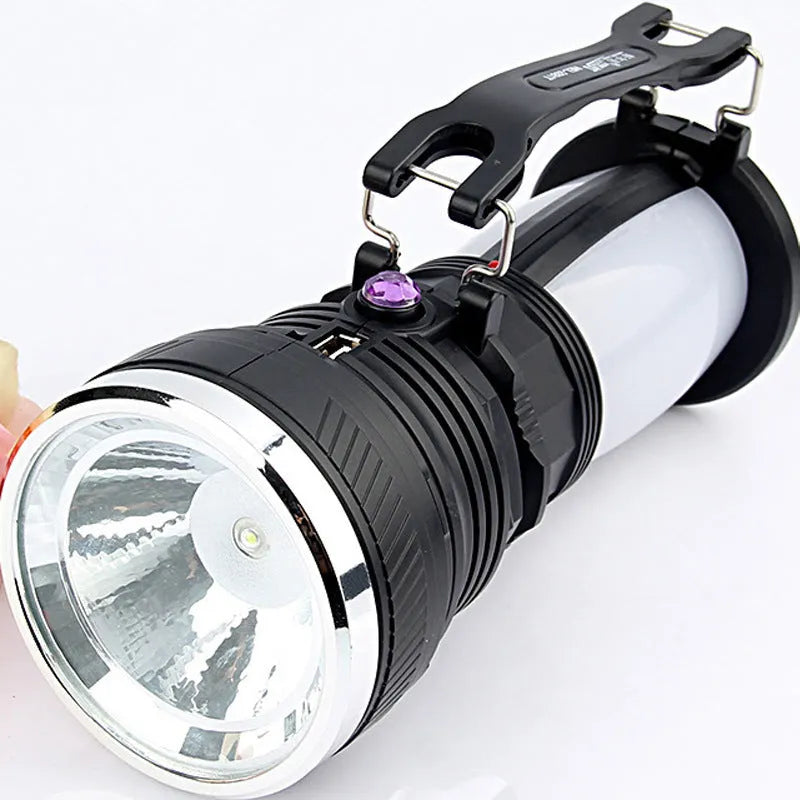 Black solar-powered LED flashlight with USB charging port.