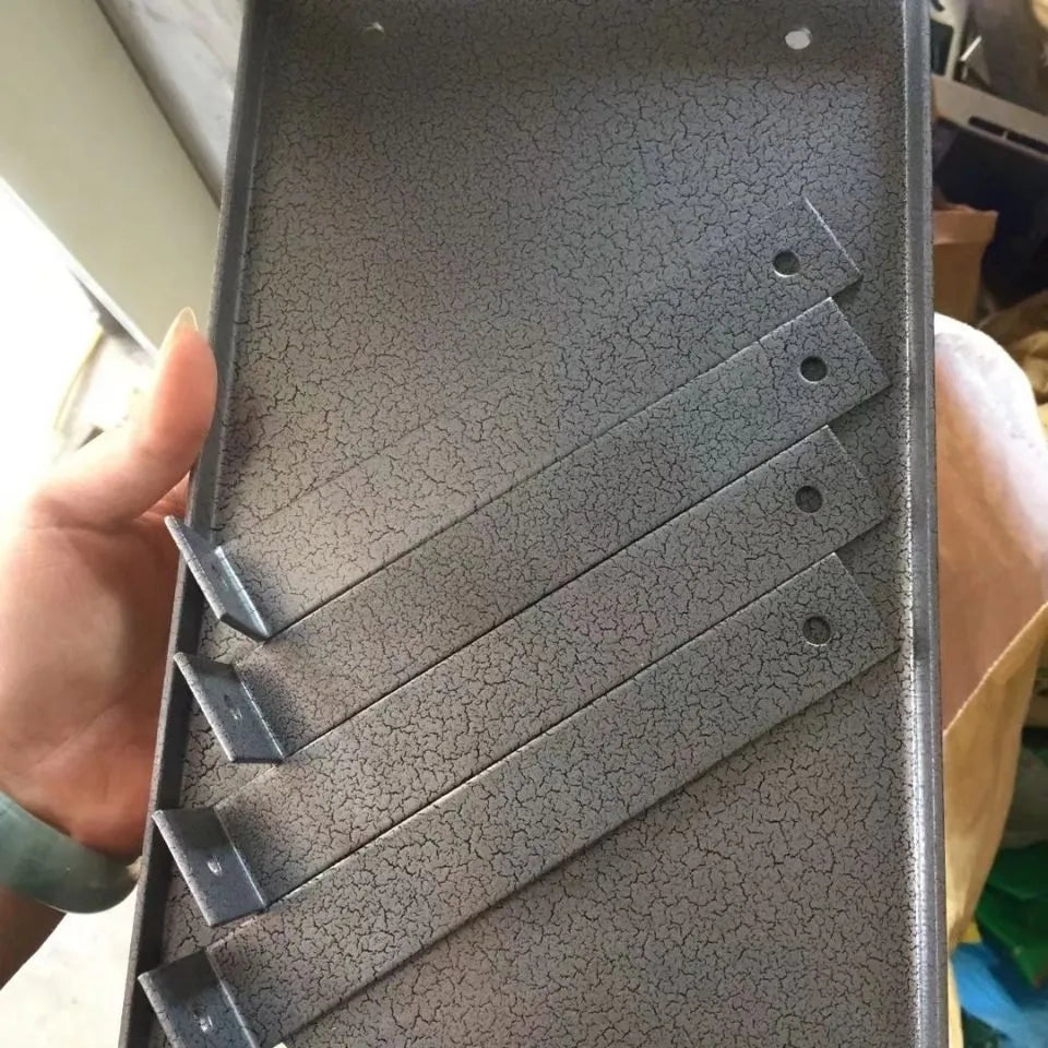 Black iron flip chip bracket for holding a portable electric planer inverted.