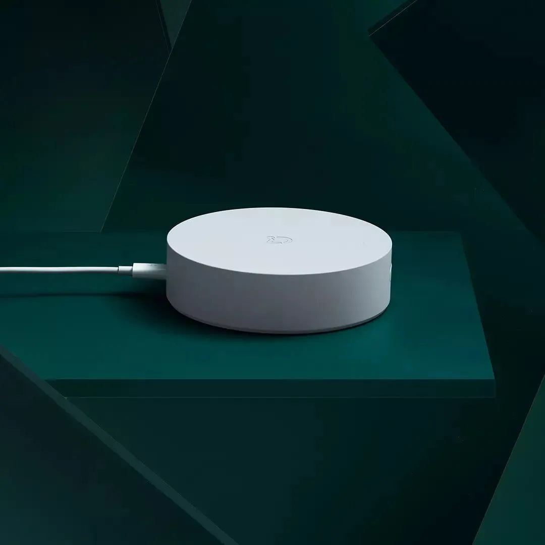 White circular Xiaomijia smart home gateway with UK plug for wireless remote control
