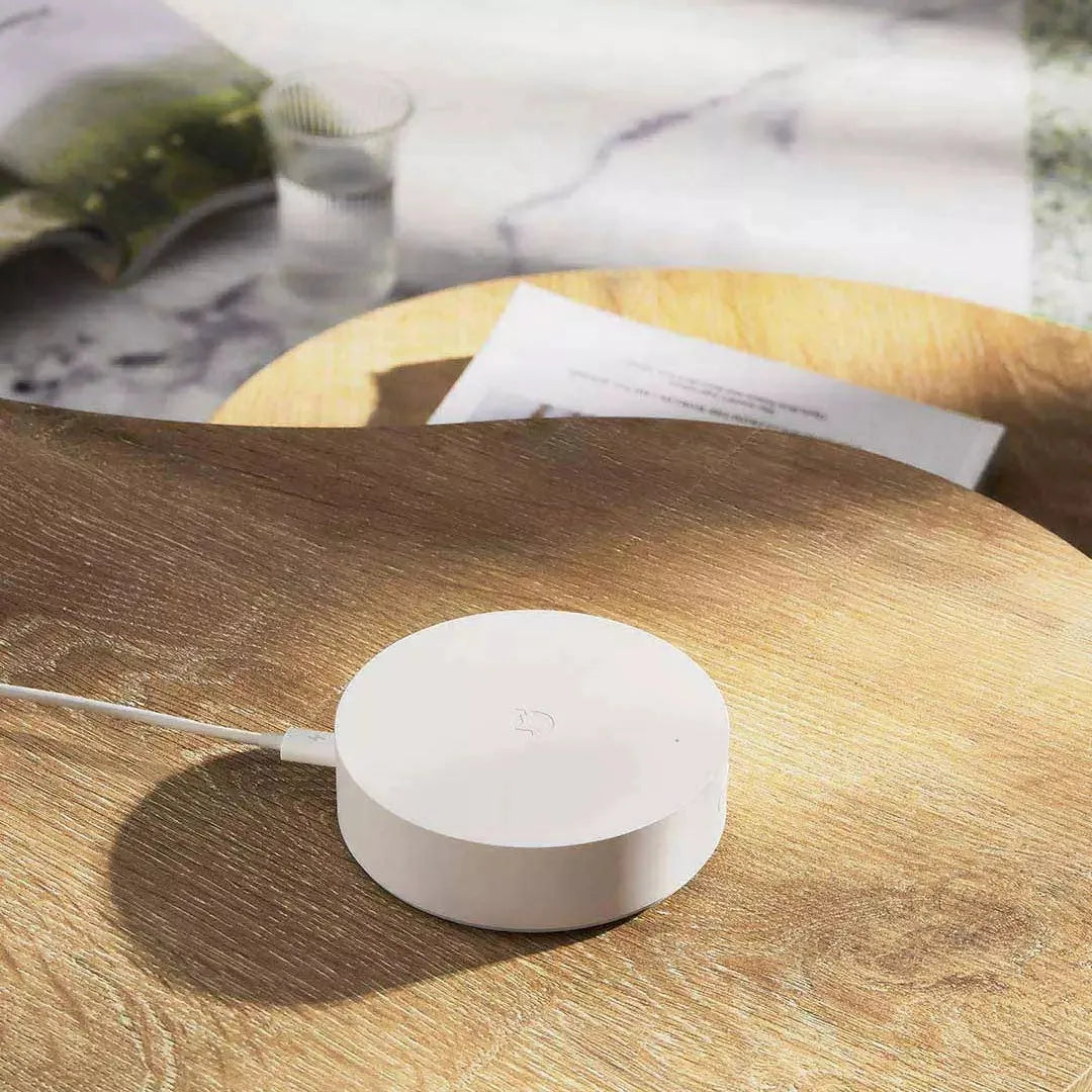 White circular Xiaomijia smart home gateway with UK plug for wireless remote control