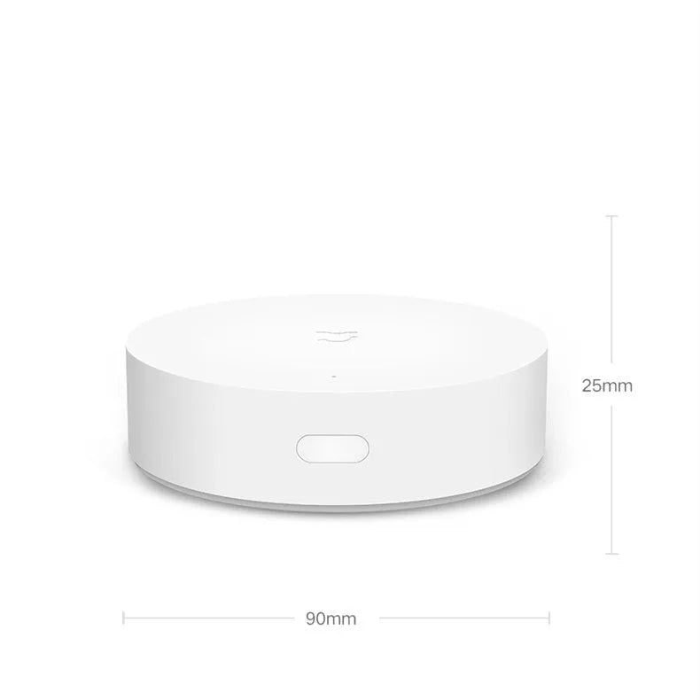 White circular Xiaomijia smart home gateway with UK plug for wireless remote control